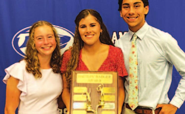 Abby Valdez, left, Kailr Clements and James Vasquez pose with the Battlin’ Badger award on Monday night. COURTESY PHOTO