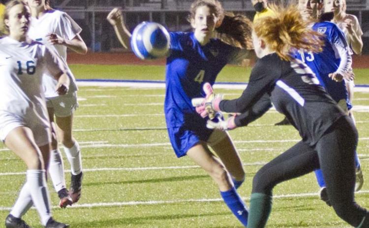Nyla Long (4) and Hailey Colbath (13) follow a shot toward the Academy goal in a close district loss on Friday. JEFF LOWE | DISPATCH RECORD