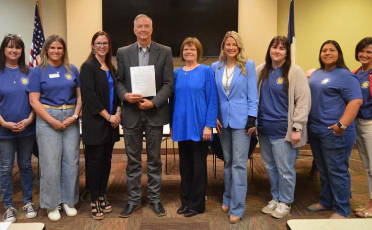 Lampasas Child Protective Services board members and Hill Country Children’s Advocacy Center staff pose for a photo with County Judge Randy Hoyer, who holds a proclamation in support of April’s designation as Child Abuse Prevention Month. ERICK MITCHELL | DISPATCH RECORD
