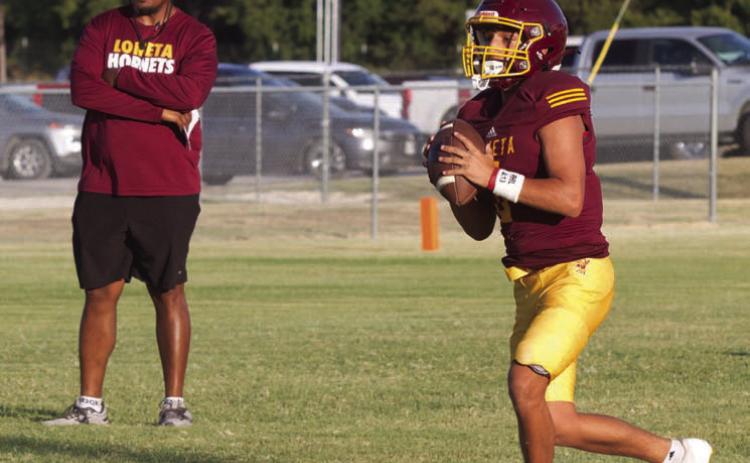 Lometa’s Jose Carbajal rolls out of the pocket as head coach Terrence Wadley observes during Thursday’s home scrimmage against Menard and May. ERICK MITCHELL | DISPATCH RECORD