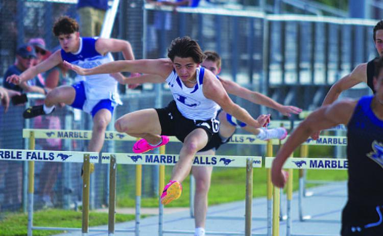 Asa White leaps over a hurdle during the 110-meter race. He qualified for area in both hurdles races. HUNTER KING | DISPATCH RECORD
