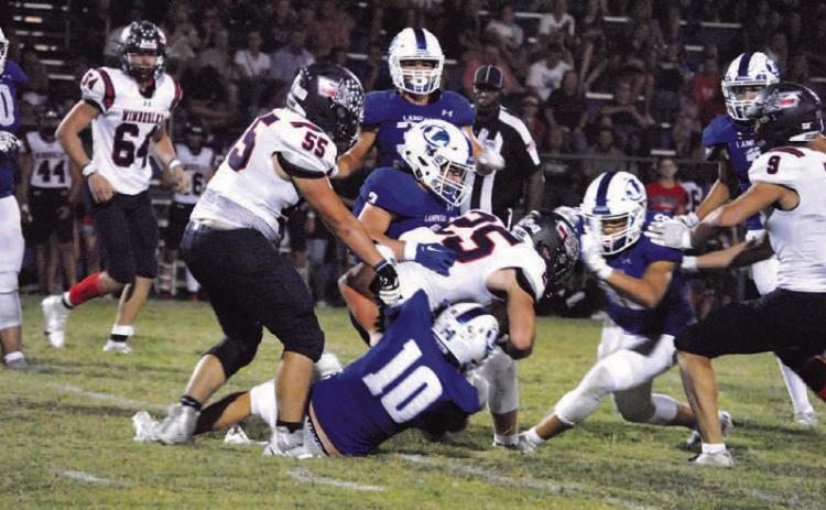 Brock Langford (10) and Reed Jerome (3) are in on the tackle of the Wimberley ball carrier. HUNTER KING | DISPATCH RECORD