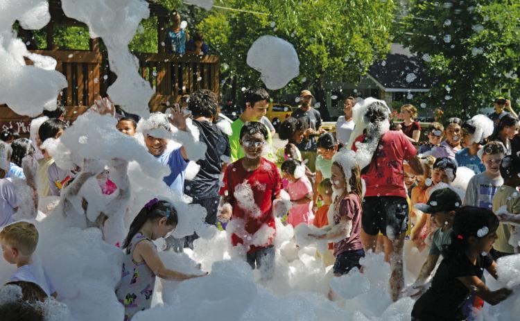 Children partied under a blanket of foam during the Lampasas Public Library’s Summer Reading program launch party on Friday. ERICK MITCHELL | DISPATCH RECORD