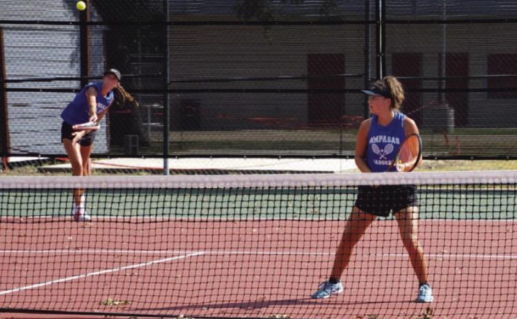 COURTESY PHOTO | KENNETH PEISER Chesley Breuer serves as Caroline White watches during a doubles match last week.