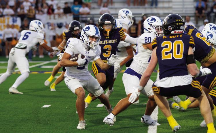 Jonathan Bowling returns the opening kickoff at Stephenville, weaving through defenders. PHOTO BY ANA SOFIA MEYER | DISPATCH RECORD