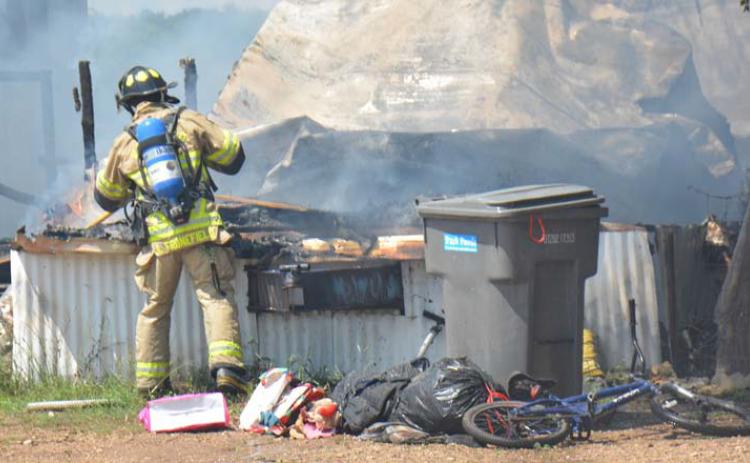 In this August 2022 file photo, a Lampasas firefighter extingushes a fire at a mobile home. Lampasas Fire Chief Jeff Smith encourages every household to have an emergency plan. FILE PHOTO