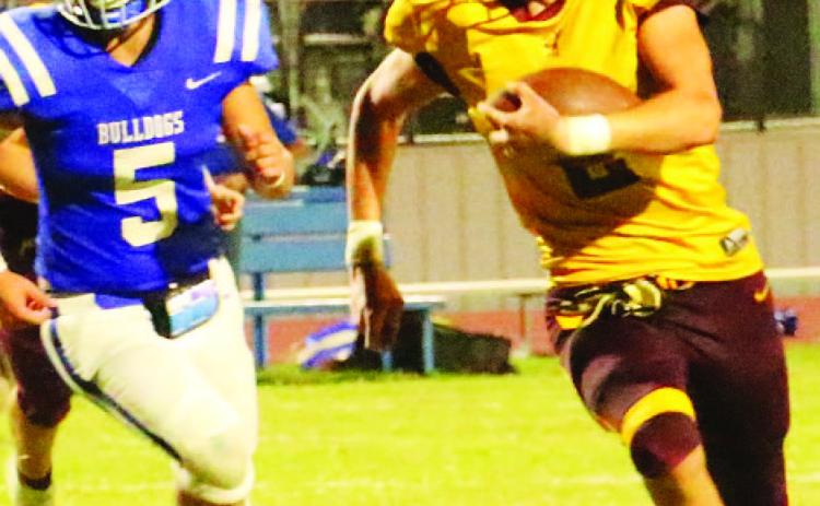 COURTESY PHOTO | MEGAN LUSTY Stone Carr-Jones looks for running room past a Bulldog defender. Carr-Jones finished with 161 yards and a touchdown in the Hornets’ win Friday night.