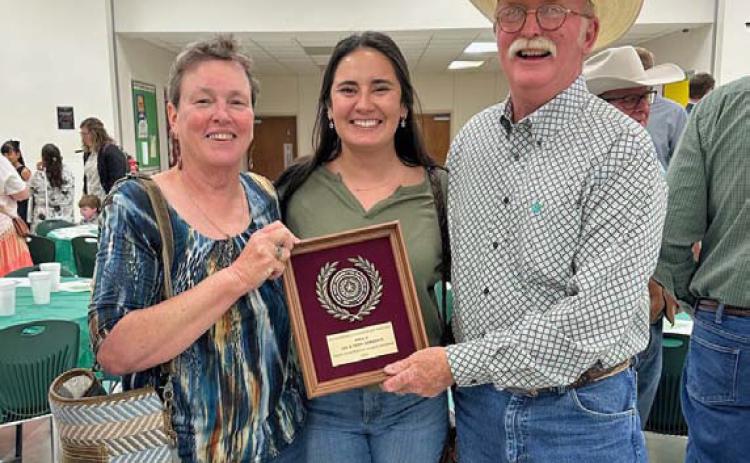From left to right are Teri Gernentz, Shelby Hilbert and Lee Gernentz with the plaque honoring the Gernentzes for being named the Area V Outstanding Conservation Rancher. courtesy photo