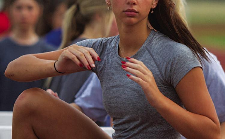 HUNTER KING | DISPATCH RECORD Landry White works on flexibility in the hurdles.