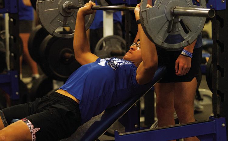 Ty Johnson lifts during incline bench press at the first day of SWAT on Monday. HUNTER KING | DISPATCH RECORD