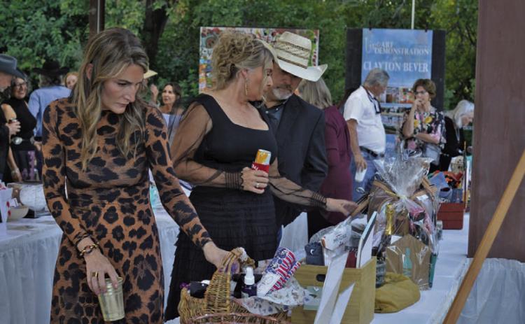Boots and Blazers Ball attendees were busy eyeing silent aution items on display during Saturday’s event for the Lampasas Association for the Arts. ERICK MITCHELL | DISPATCH RECORD