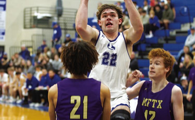 Carter Johnson rises up over a Marble Falls defender for two points in last Thursday’s game. HUNTER KING | DISPATCH RECORD