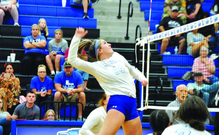 Avery Bolm jumps for a spike in a game at home earlier this season. HUNTER KING | DISPATCH RECORD