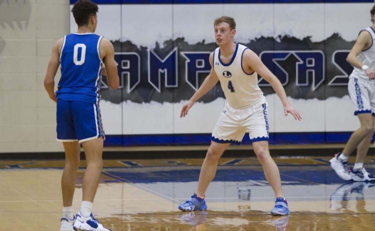 Quinn Pace plays defense on a Whitney guard during last Friday’s contest. Pace has scored in double digits in his last two games. HUNTER KING | DISPATCH RECORD