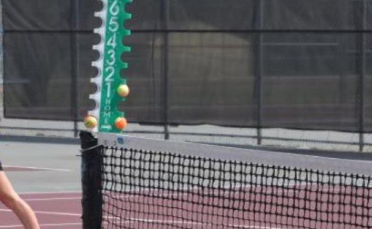 Abby Valdez plays the net while Kailr Clements serves during girls’ doubles at Brownwood on Thursday. KENNETH PEISER | COURTESY PHOTO