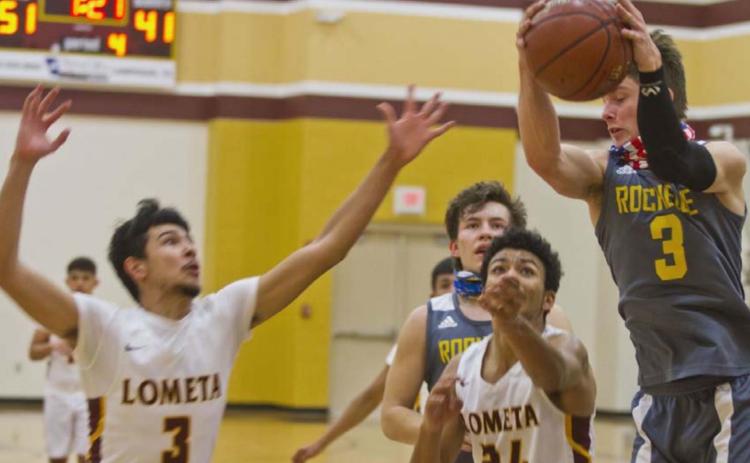Alonso Caso (3) and Dyllen Workmon (24) swarm a Rochelle Hornet player during Lometa’s 15-0 run in the second half on Friday. JEFF LOWE | DISPATCH RECORD