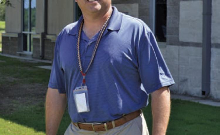 Paul Weinheimer stands outside Lampasas High School, where he has gone from teacher and football coach to assistant principal to now principal at the campus. ERICK MITCHELL | DISPATCH RECORD
