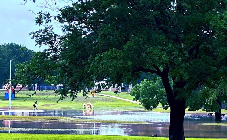 Heavy rains soaked Lampasas on Thursday and turned Campbell Park and the Hanna Springs Sculpture Garden area into a retention pond for the water. One teenager took advantage of the pooling effect and enjoyed skimming over the surface. STEPHANIE FITZHARRIS | COURTESY PHOTO