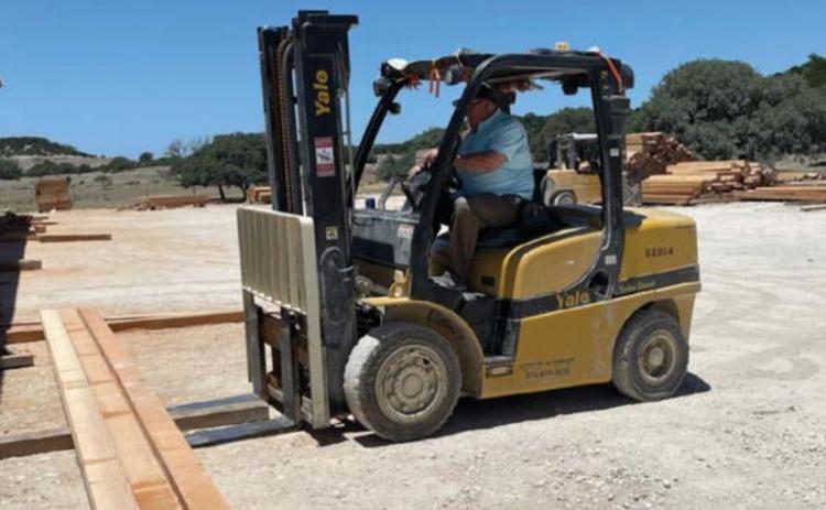 Herb Pearce loads lumber at his BHR Timber facility. He is one of a group of local builders who will provide mentorship this fall for students in a construction science course at the high school. MASON HINES | DISPATCH RECORD