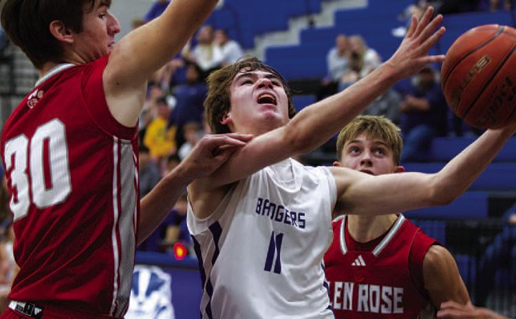 Jax Pratus fights through contact to finish at the rim against Glen Rose during the Badgers’ game. HUNTER KING | DISPATCH RECORD