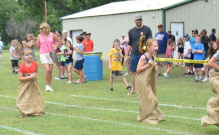 Kids hopped their way to the finish line in this year’s sack race during Kids’ Day last Friday. The event was part of the town’s Spring Ho festival. MONIQUE BRAND | DISPATCH RECORD