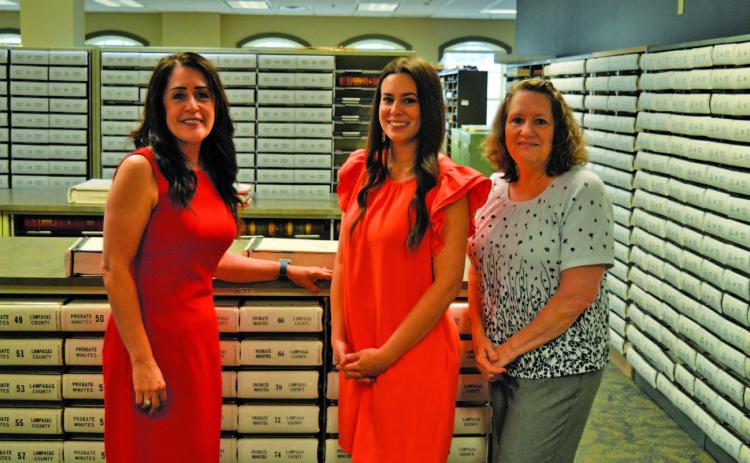 Lampasas County Clerk Dianne Miller and her staff members Dallas Munoz and Dawn Rodman, left to right, stand in a storage room that contains hard copies of county land records. On June 10, these books of property records such as deeds, judgments and tax liens will be taken to a Dallas imaging facility to be digitized. ERICK MITCHELL | DISPATCH REACORD