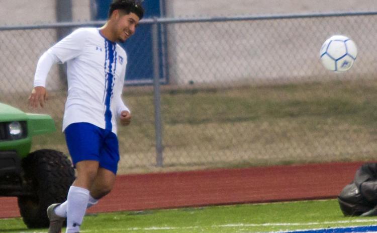Victor Castruita kicks the ball near the sideline before going on to score one of the varsity’s early goals against the alumni on Tuesday. JEFF LOWE | DISPATCH RECORD