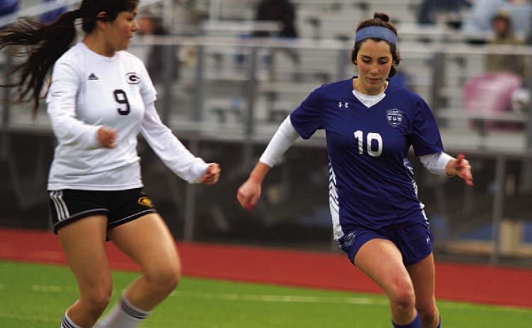 Liliana Fryer dribbles past a defender. As a freshman, she has been an important player this season. FILE PHOTO