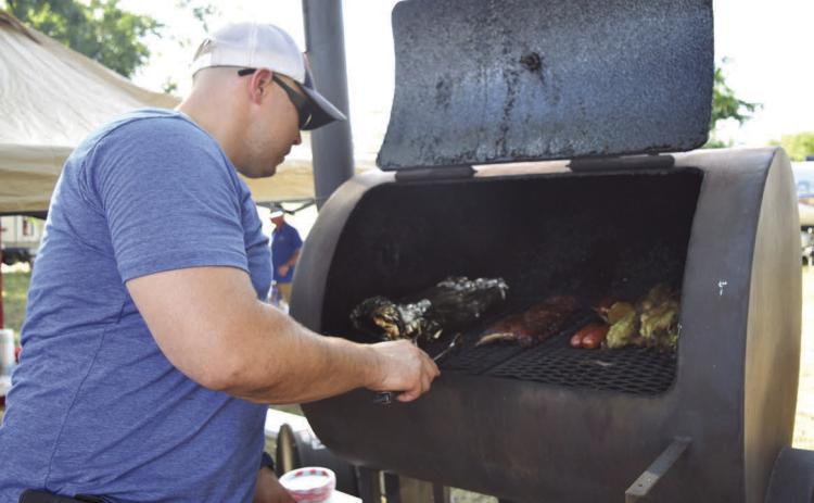 An LTX BBQ Fest cook-off contestant loads his smoker full of meats at a previous edition of the event. As that event has faded, Michael Olson, a former organizer of the LTX BBQ Fest and Creating Badger Builders member, has launched a new competition. The “Hotter than Hell 2.0” Barbecue Cookoff hosted by the local nonprofit plans to raise money for trade school scholarships through the contest. FILE PHOTO