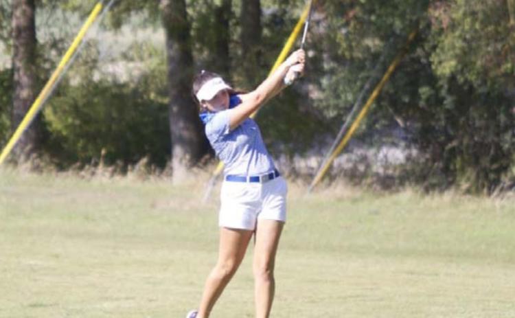 Paige Rutland finishes on a shot from the fairway on hole 5 at Hancock Park Golf Course. HUNTER KING | DISPATCH RECORD