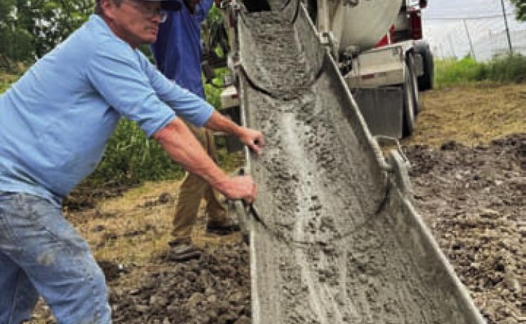 RKJ Construction employees prepare to pour cement for the bridge support footings. Rex Johnson of RKJ Construction and his late wife were donors of the land that has become Cooper Spring Nature Park. COURTESY PHOTO