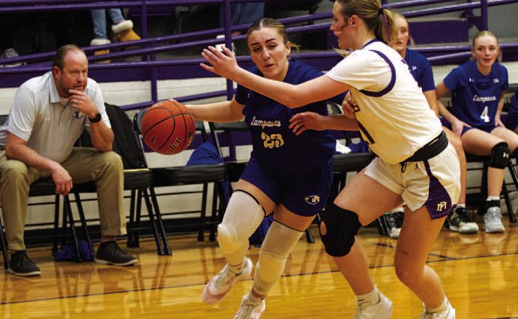 Payton Crawford dribbles baseline against Marble Falls as players on the bench look on. HUNTER KING | DISPATCH RECORD