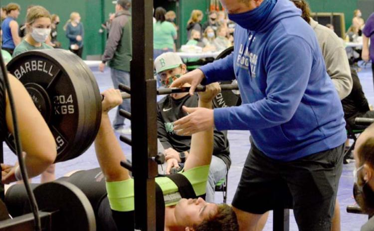 John Long improved his school records in the 308-pound weight class at Burnet. Assistant coach Heath Naragon spots for him. JEFF LOWE | DISPATCH RECORD