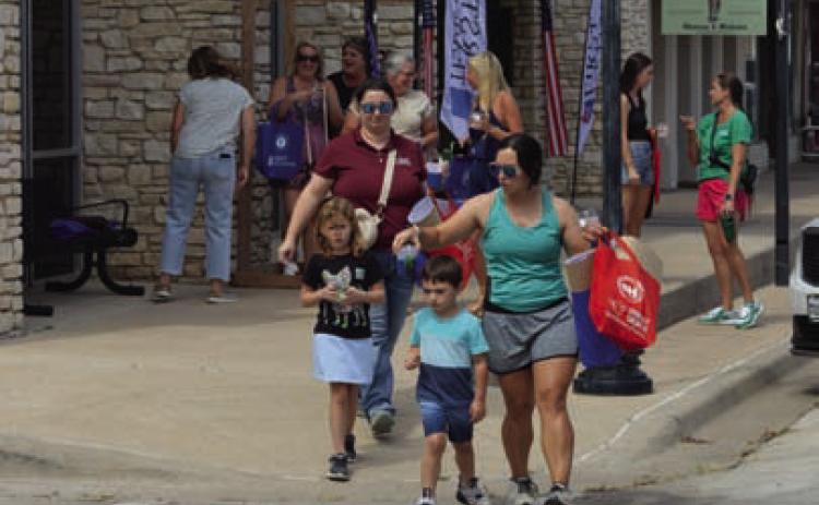 Sip ’N’ Shop customers enjoyed strolling the downtown square during Tuesday’s event. ERICK MITCHELL | DISPATCH RECORD