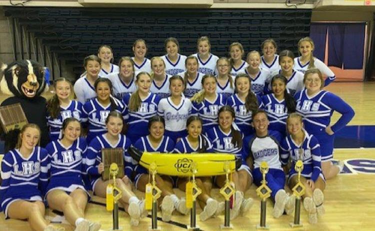 The Lampasas High School varsity and junior varsity cheer teams pose with their trophies at the Universal Cheerleaders Association camp at San Angelo State last month. COURTESY PHOTO