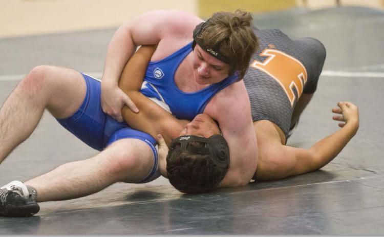 Badger wrestler Jonathan Dill, left, won by default against Hutto on Wednesday after the Hippo locked hands. JEFF LOWE | DISPATCH RECORD