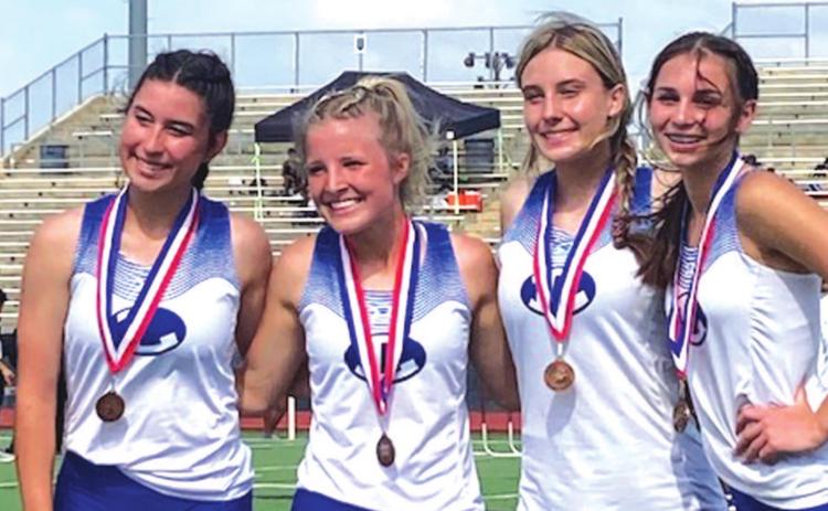 Gracie Ullevig, left, Morgan Myers, Cobie Chandler and Landry White pose for a photo after finishing fourth in the 4x200-meter relay. COURTESY PHOTO