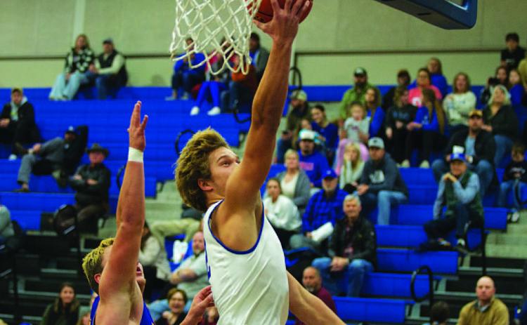 Haegan Oncken lays a ball off the backboard for two points on the fast break against Blanco. HUNTER KING | DISPATCH RECORD