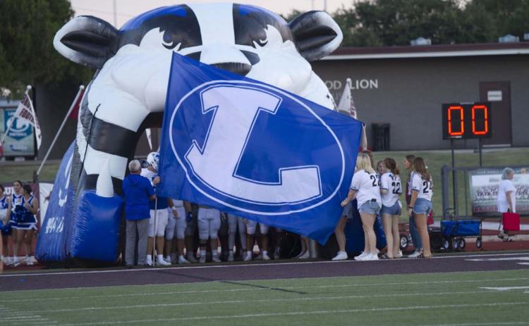 The Lampasas flag flies in front of the team as the Badgers prepare to run out of the tunnel before their week one game against Brownwood last week. HUNTER KING | DISPATCH RECORD