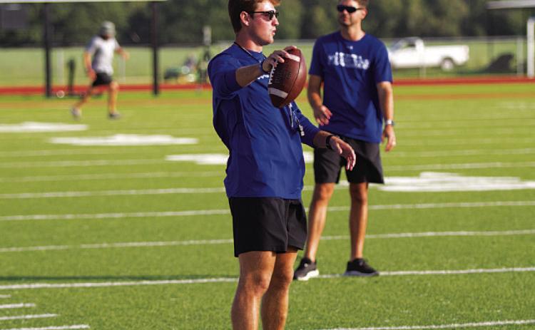Assistant football coach Hadley Berry works with receivers at football camp. HUNTER KING | DISPATCH RECORD