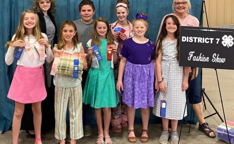 These 4-H members participated recently in the District 7 Fashion Show. Front row, from left, are Emerie Greenberg, Eve Walters, Vivien Martin, Lauren Martin and Rylee McKittrick; back row are Katelyn Martin, David Carr, Allison Martin and Family &amp; Consumer Science Extension Agent Karen DeZarn. COURTESY PHOTO