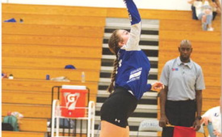 Abbey Green hits a serve for the Lady Badgers. HUNTER KING | DISPATCH RECORD