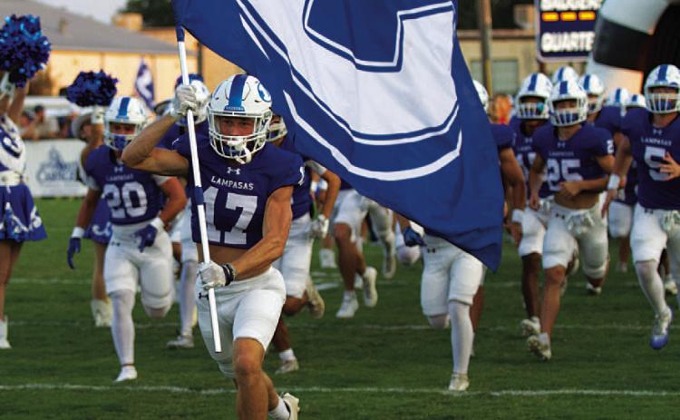 HUNTER KING | DISPATCH RECORD Sean Smith leads the Badgers onto the field before every game.