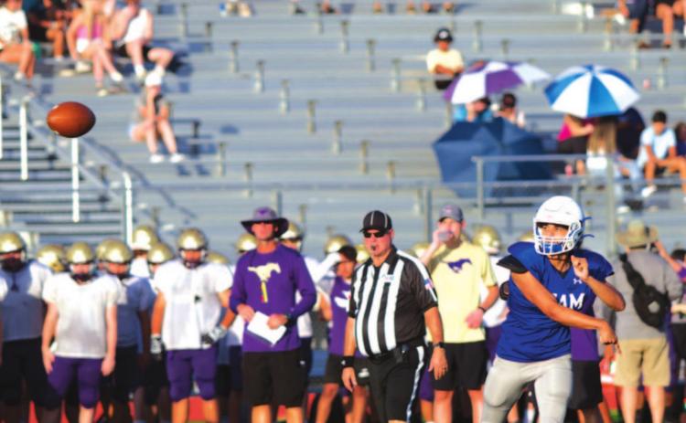 Dylan Sanchez throws a pass during a scrimmage against Marble Falls at the beginning of last season. The Badgers and Mustangs will compete in District 13-4A in the fall. FILE PHOTO