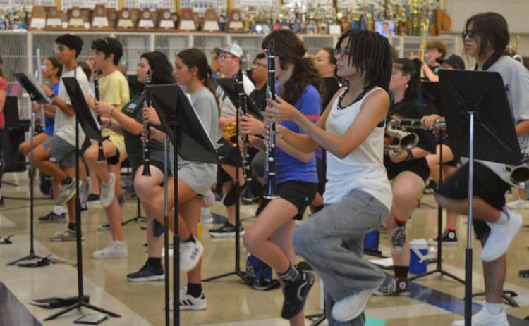 The Lampasas High School Badger Band practices some drill movments for its James Bondthemed show away from the heat on Tuesday afternoon. Erick Mitchell | dispatch record