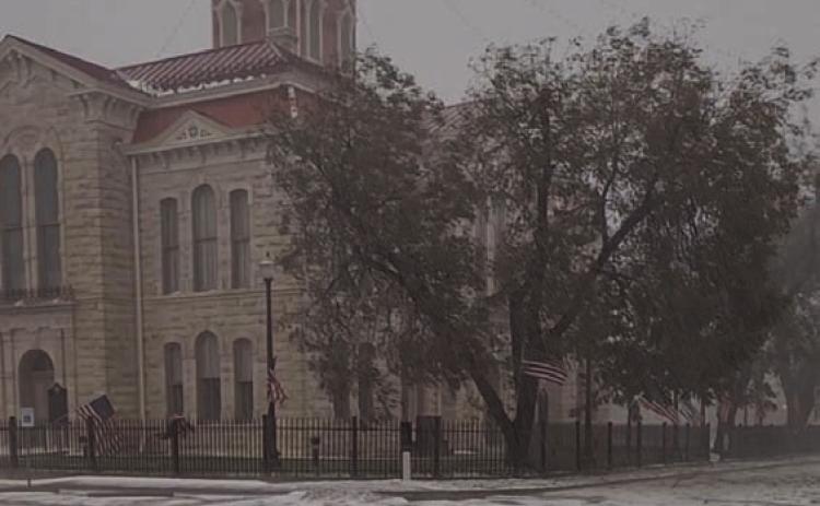 The downtown courthouse square appears to be blanketed in snow after a hail storm Friday. The hail pummeled trees, buildings and vehicles, and left broken limbs and leaves plastered across yards and sidewalks. TERESA THORNTON | DISPATCH RECORD