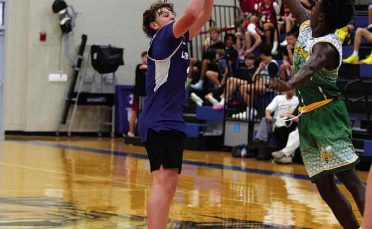 Aidan Nuckles shoots over the outstretched hand of a defender. HUNTER KING | DISPATCH RECORD