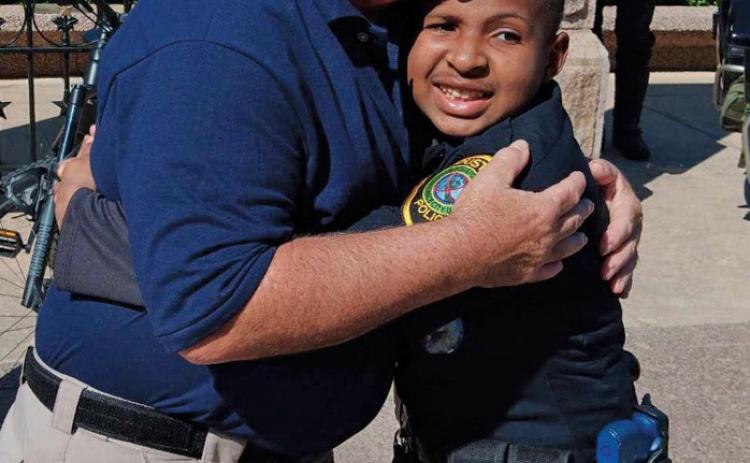Paul Miceli embraces Devarjaye “DJ” Daniel at Daniel’s honorary swearing-in at the Texas Capitol. erick mitchell | dispatch Record