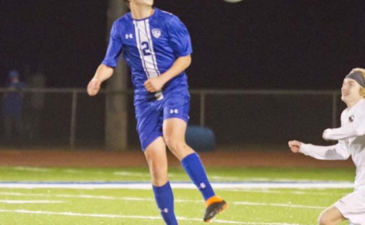Cody Woods plays the ball at midfield in a recent district match. JEFF LOWE | DISPATCH RECORD