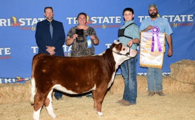 Cort Maples poses for a photo with his miniature Hereford after being named Grand Champion Junior Showman at the Tri State Fair in Amarillo. Courtesy photo